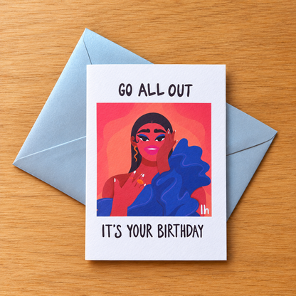 Go All Out greeting card by Lo Harris, styled on a table