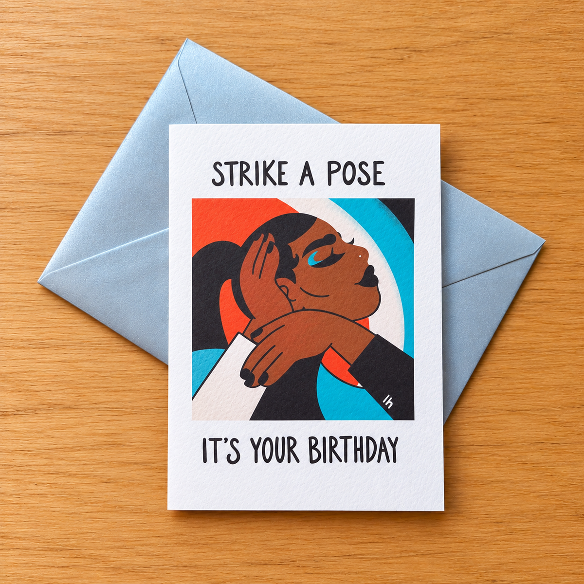 Strike a Pose greeting card by Lo Harris, styled on a table